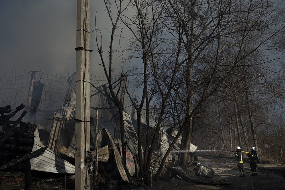 Firefighters extinguish building destroyed by Russian strike.