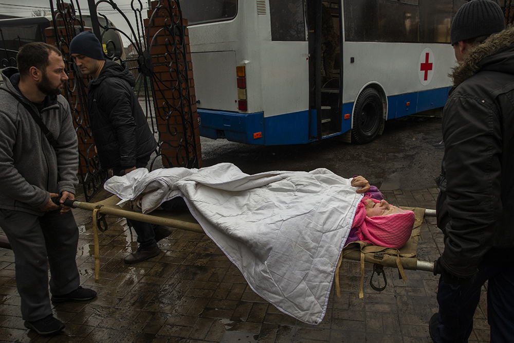 An elderly woman being evacuated from Church of Grace in Pokrovsk