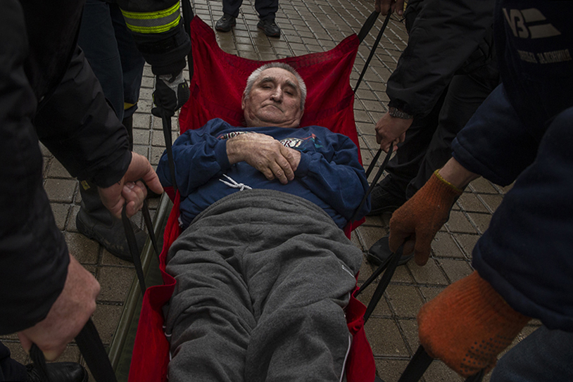 Elderly man being lifter onto a train at Pokrovsk railway station