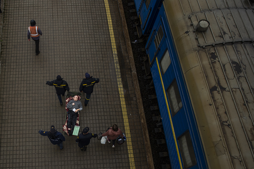 Person being carried to a train to evacuate Pokrovsk