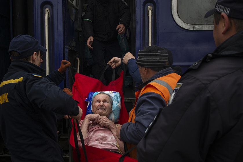 Elderly man being loaded on a train at Pokrovsk railway station to evacuate Donbas region 