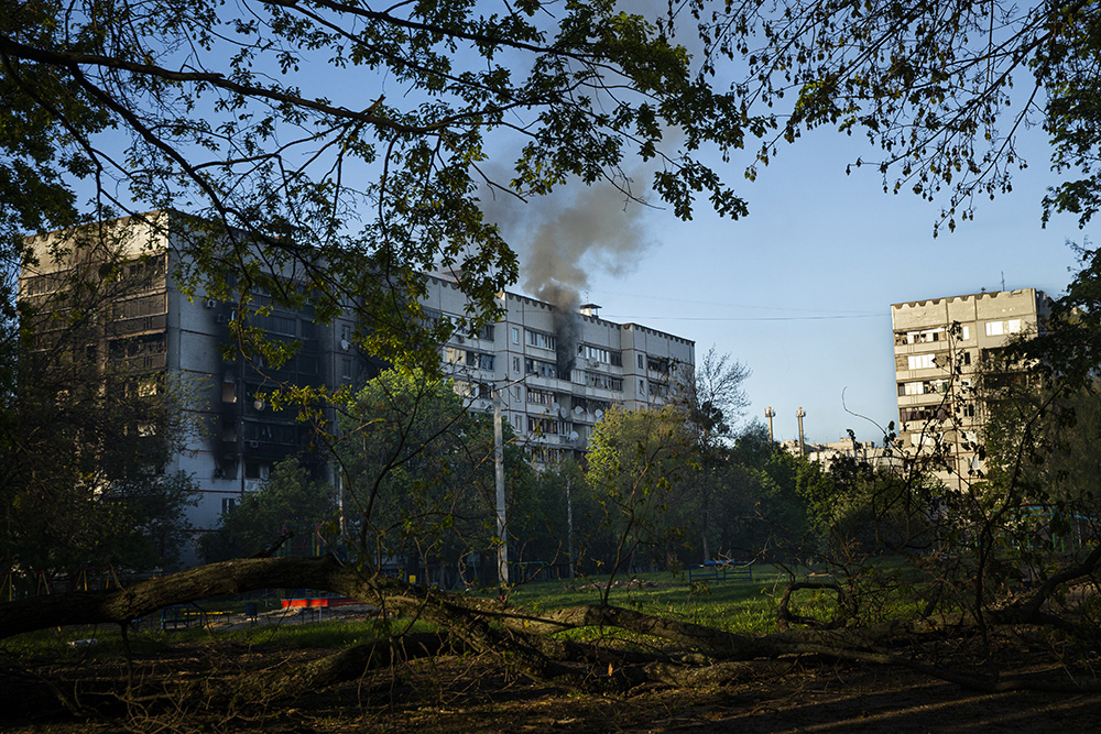 REsidential building burning after Russian  forces shell Saltivka
