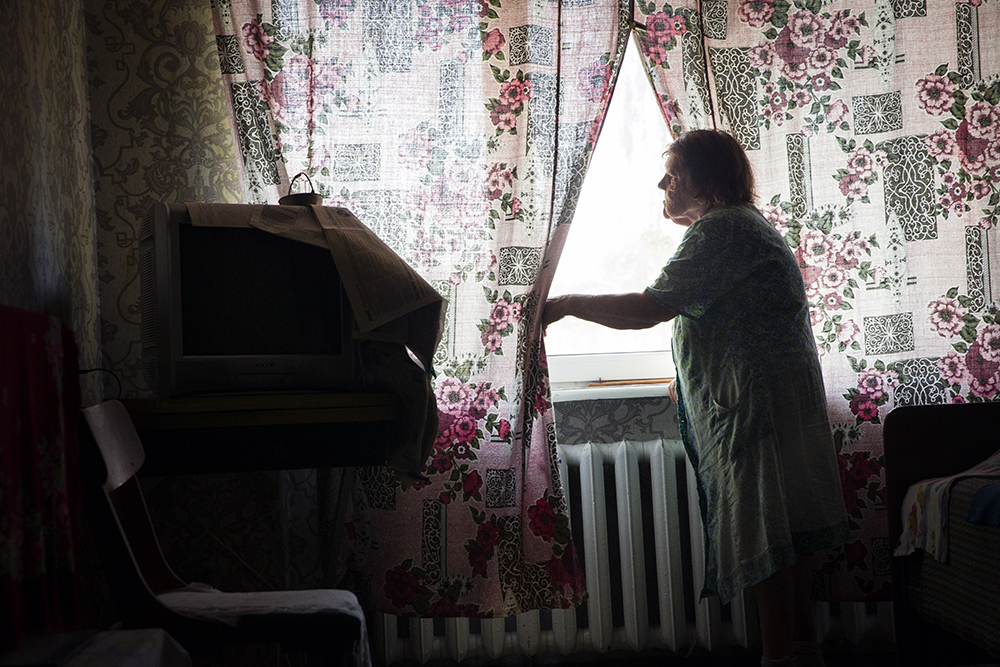 Elderly Woman Looks Out Her Window in Bakhmut